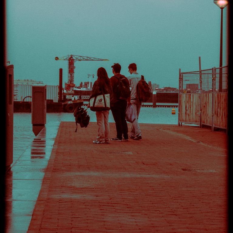 three people on a pier