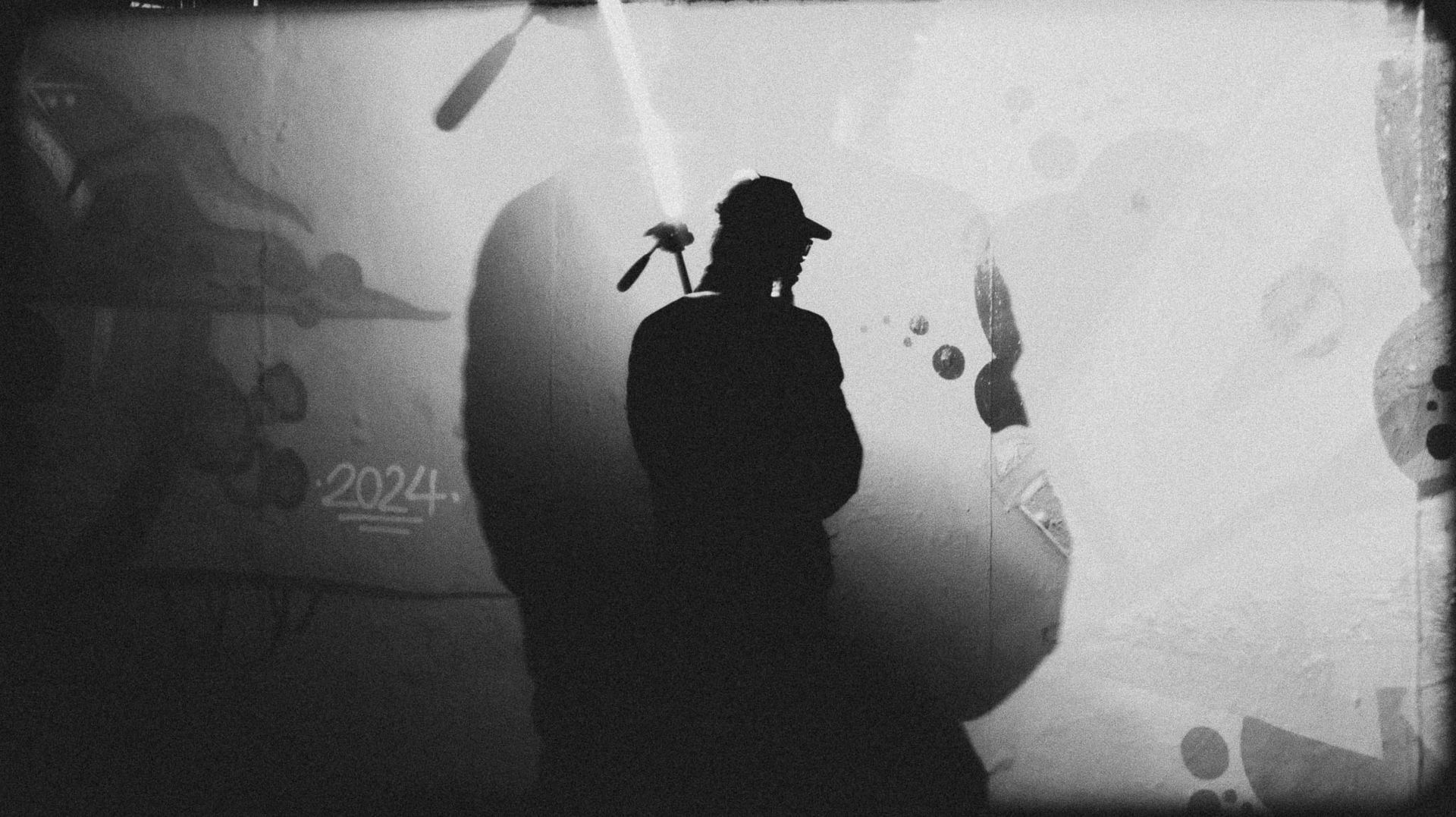 a black and white image of a man holding a light